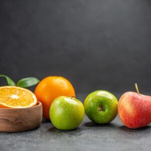 close-up-view-benefit-fruit-salad-with-fresh-oranges-green-apple-dark-table